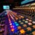 Close-up of a sound mixing console with colorful illuminated controls