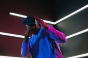 Person wearing a virtual reality headset beneath geometric LED lights