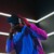 Person wearing a virtual reality headset beneath geometric LED lights
